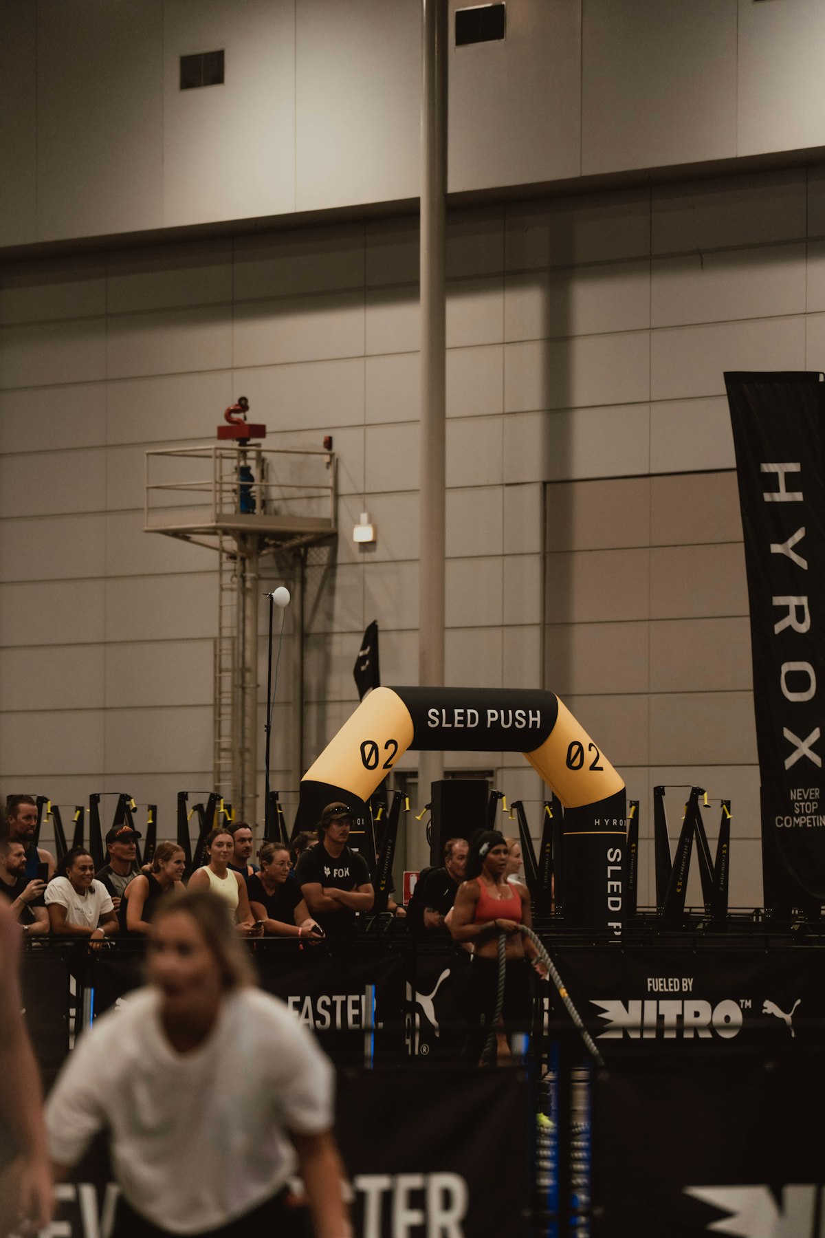 Athletes performing a sled push during Hyrox training
