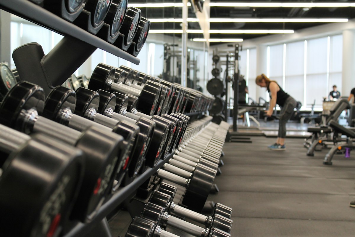Open gym floor with dumbbell rack and free weights